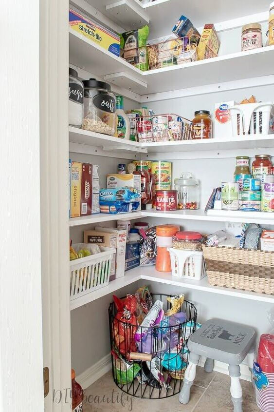 30 affordable pantry organization storage ideas you need to see, Pantry Organization Ideas White painted shelves with light grey walls make this pantry look fresh and clean Glass jars baskets and plastic storage bins organize packaged food