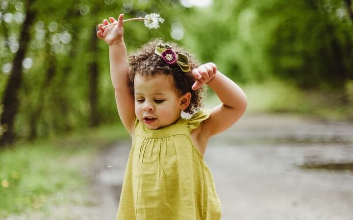 how to save money on kids clothes, pretty little girl wearing a green dress
