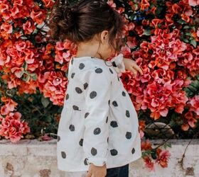 how to save money on kids clothes, girl wearing a cute outfit near pink flowers