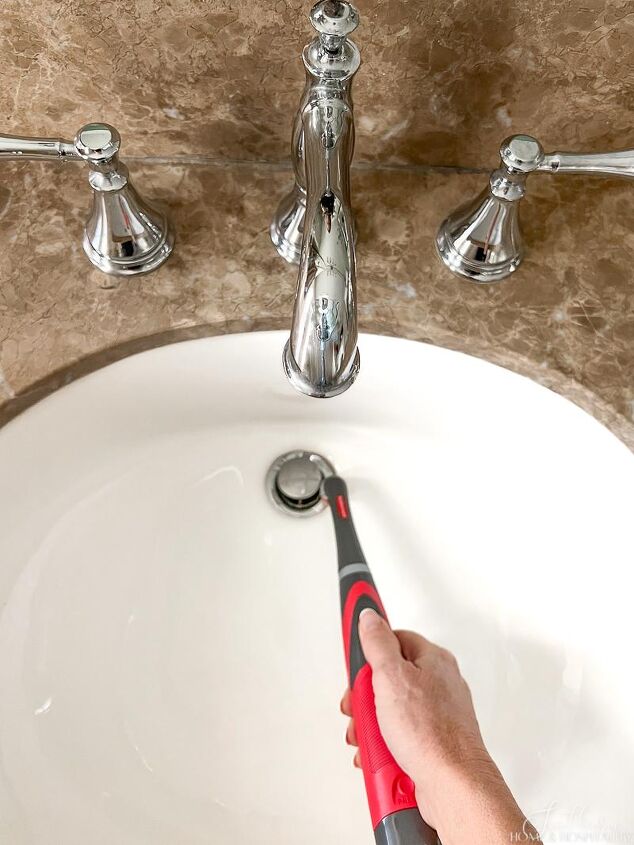 over 30 cleaning tools that make life easier, Using Rubbermaid power scrubber on bathroom sink