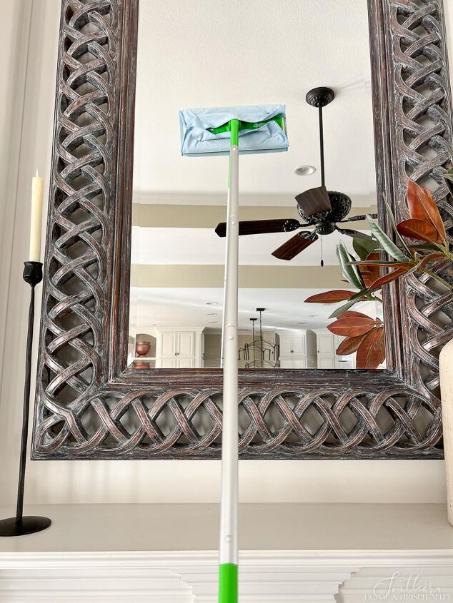 over 30 cleaning tools that make life easier, Cleaning mirror with a Swiffer mop and glass microfiber rag