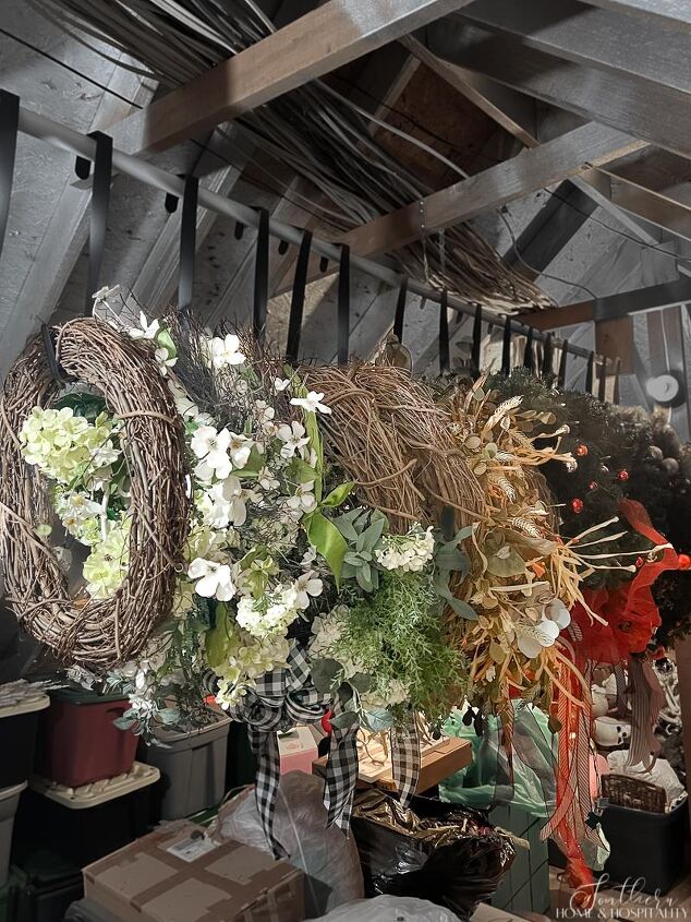 how to pack christmas decorations to make it easier next year, Wreaths hanging on a closet rod in attic