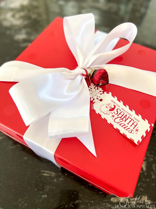 how to pack christmas decorations to make it easier next year, red gift with white bow
