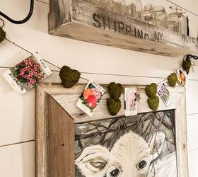 the best thrifted valentine s decor ideas, Vintage Seed Packet and moss heart garland over Faith Cow Painting