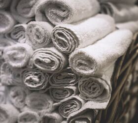 how to fold towels to save space, White towels rolled up and stacked to save space