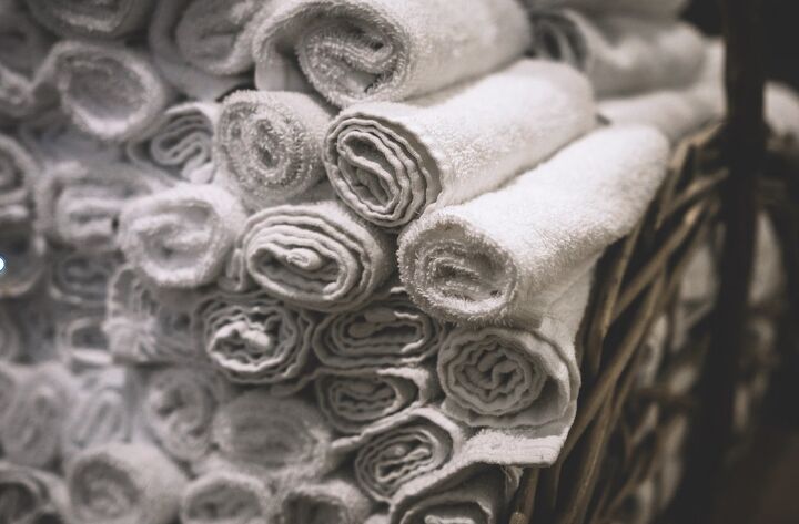 how to fold towels to save space, White towels rolled up and stacked to save space
