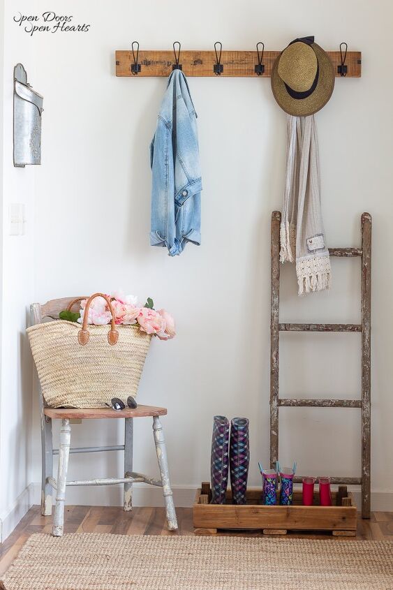 simple beautiful spring decor ideas spring home tour, small entryway with a market basket full of flowers on a vintage chair