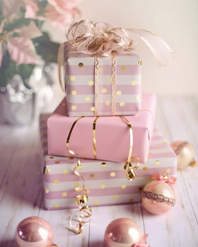 affordable luxury gifts for her, pink and white presents stacked with bulbs