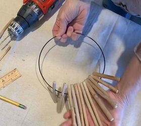 11 kirkland s home decor dupes you can diy at home, Threading sticks onto a wire ring