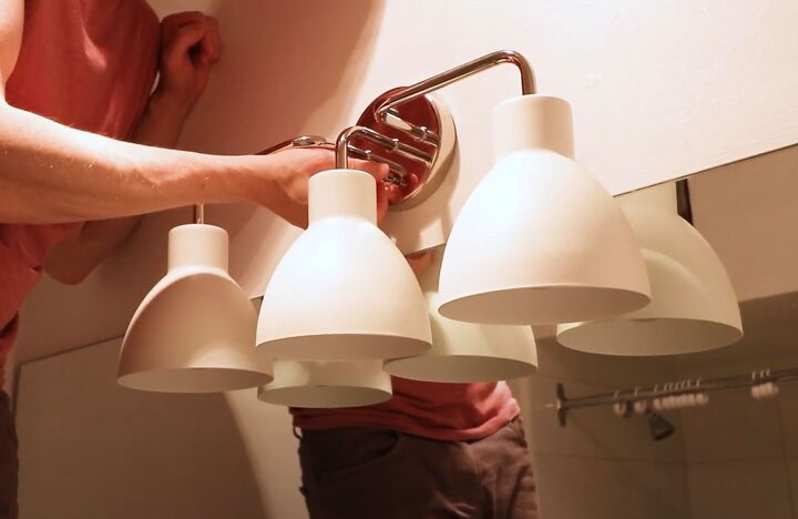 how to do a diy rental bathroom makeover on a budget, Installing a new light fixture