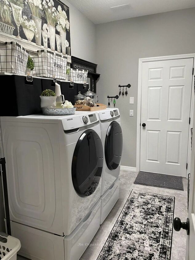 tips to create a beautiful organized laundry roomif typeof ez ad uni, An organized laundry room decorated in black white and gray