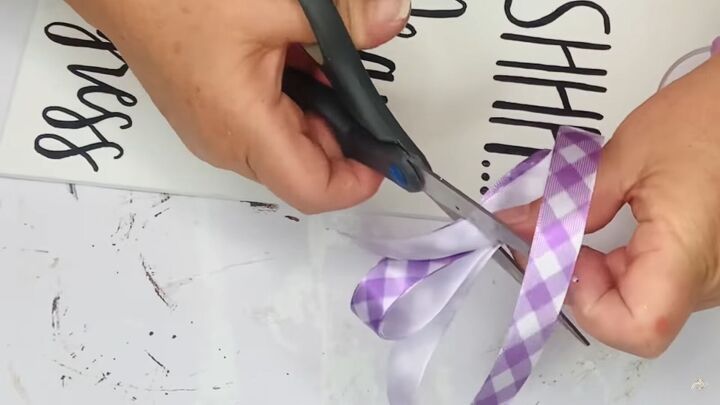3 diy spring decor crafts you can make with dollar tree items, Cutting a purple ribbon