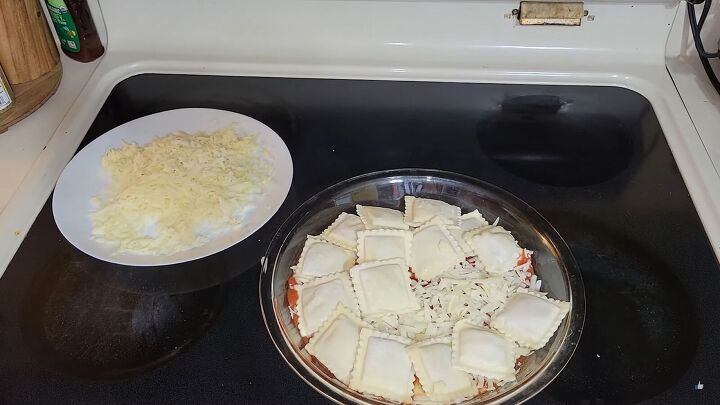 extreme budget meal plan simple and delicious meals under 25 dollars, A plate of grated cheese next to a dish with layered pasta sauce ravioli and cheese