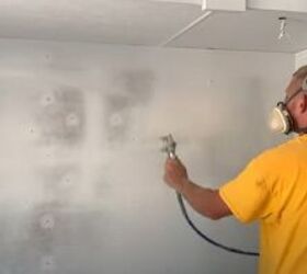 unleash your rv s beauty learn how to paint rv walls like a pro, A man spray painting the walls of an RV with a paint sprayer