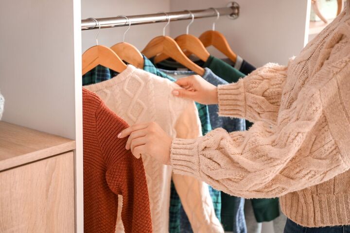 the 5 most motivating enjoyable decluttering challenges, Trying on clothes in a wardrobe