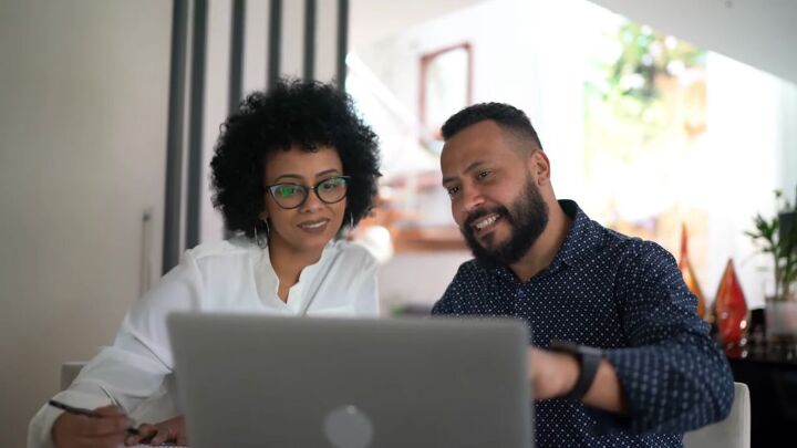 frugal partner, Couple looking at finances on laptop