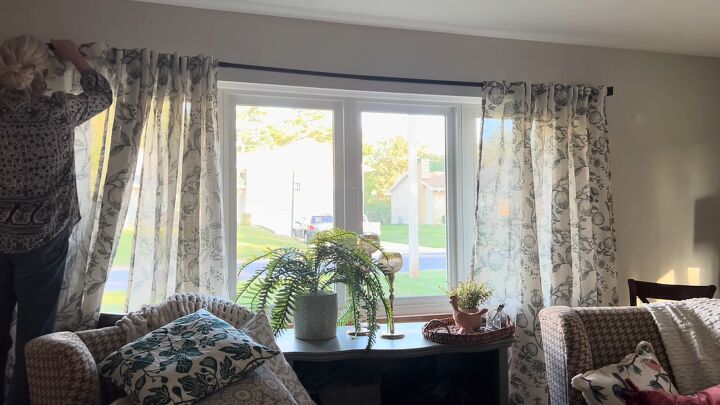 unbelievable living room transformation using only thrift store finds, Putting curtains up