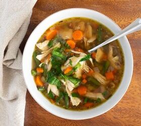 frugal meals that are also healthy delicious, Overhead bowl of chicken vegetable soup on a wooden tray