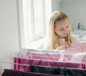 3 reasons frugal parents should let their kids earn an allowance, Child hanging laundry on a drying rack