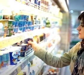 frugal living hacks to transform your spending habits, Woman buying yoghurts in the grocery store