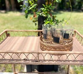 31 easy ideas to decorate a patio or porch for summer, small rattan outdoor bar cart with a tray of water glasses