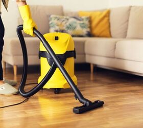 corded vs cordless vacuums which should you buy, Woman using a corded vacuum image via Canva